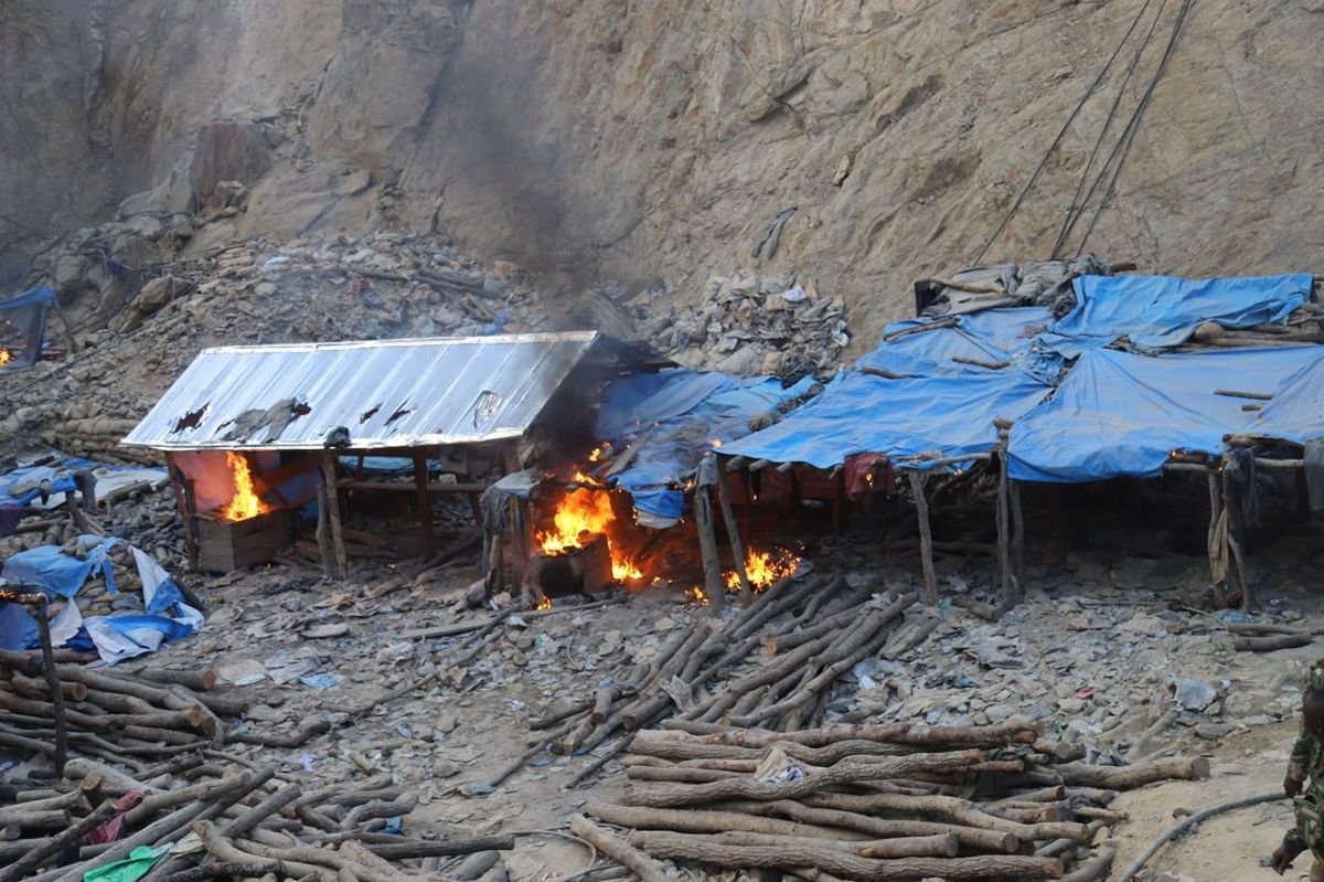 Makeshift structures burning at an illegal mining site during a NAIMOS operation