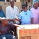 Officials present support items to a beneficiary in Zabzugu